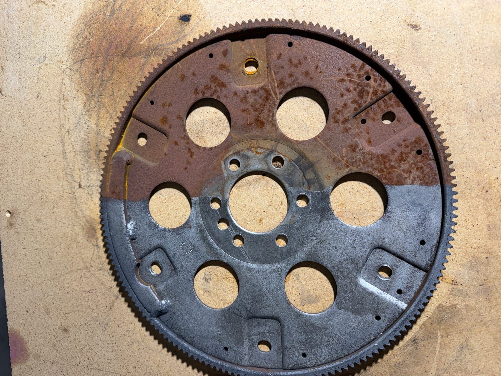 Automotive flex plate showing half cleaned and half uncleaned comparison from laser cleaning