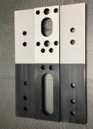 Tooling piece showing half with coating and half stripped clean by laser