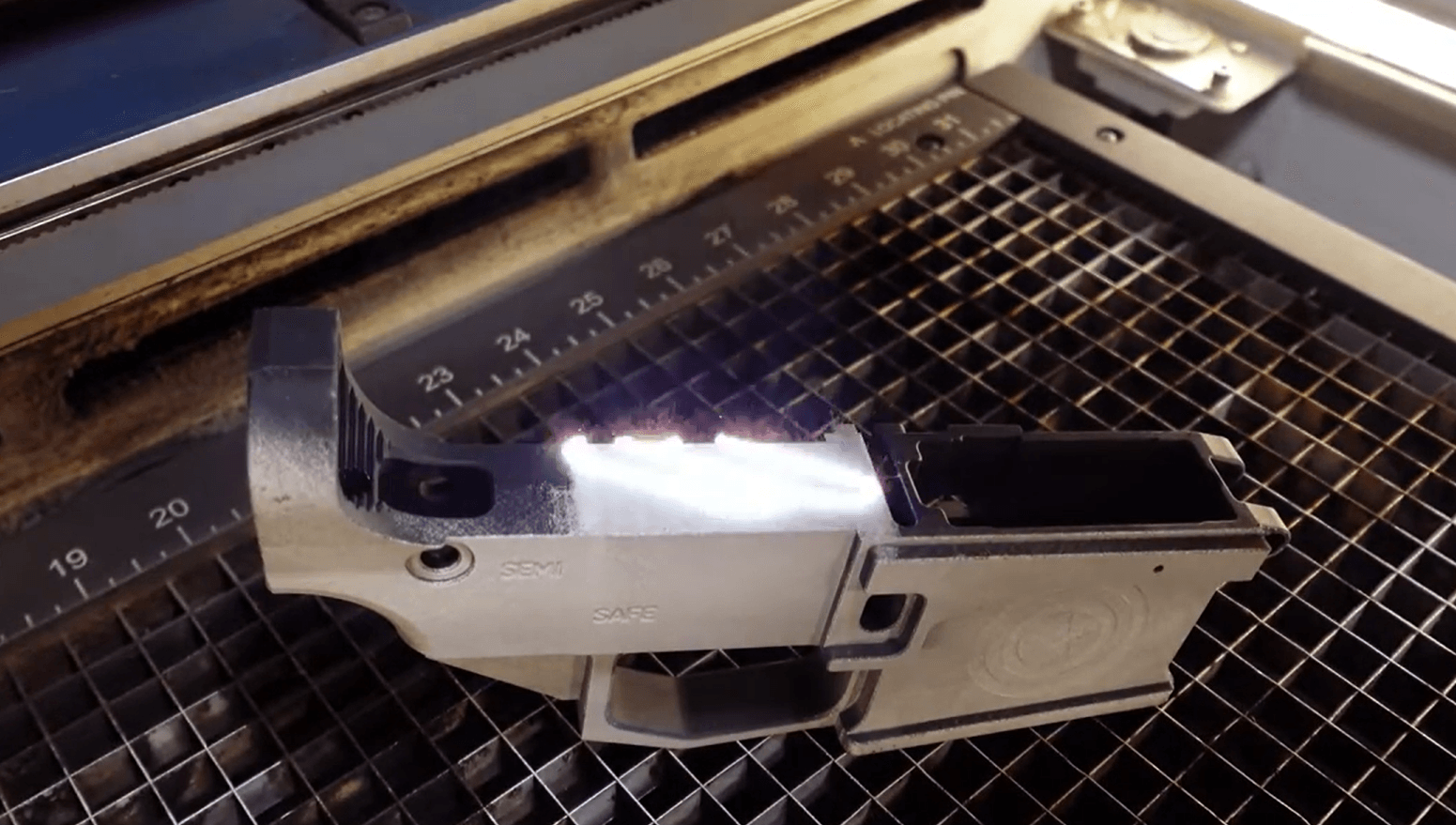 Firearm component detail showing original finish and tolerances preserved through laser cleaning