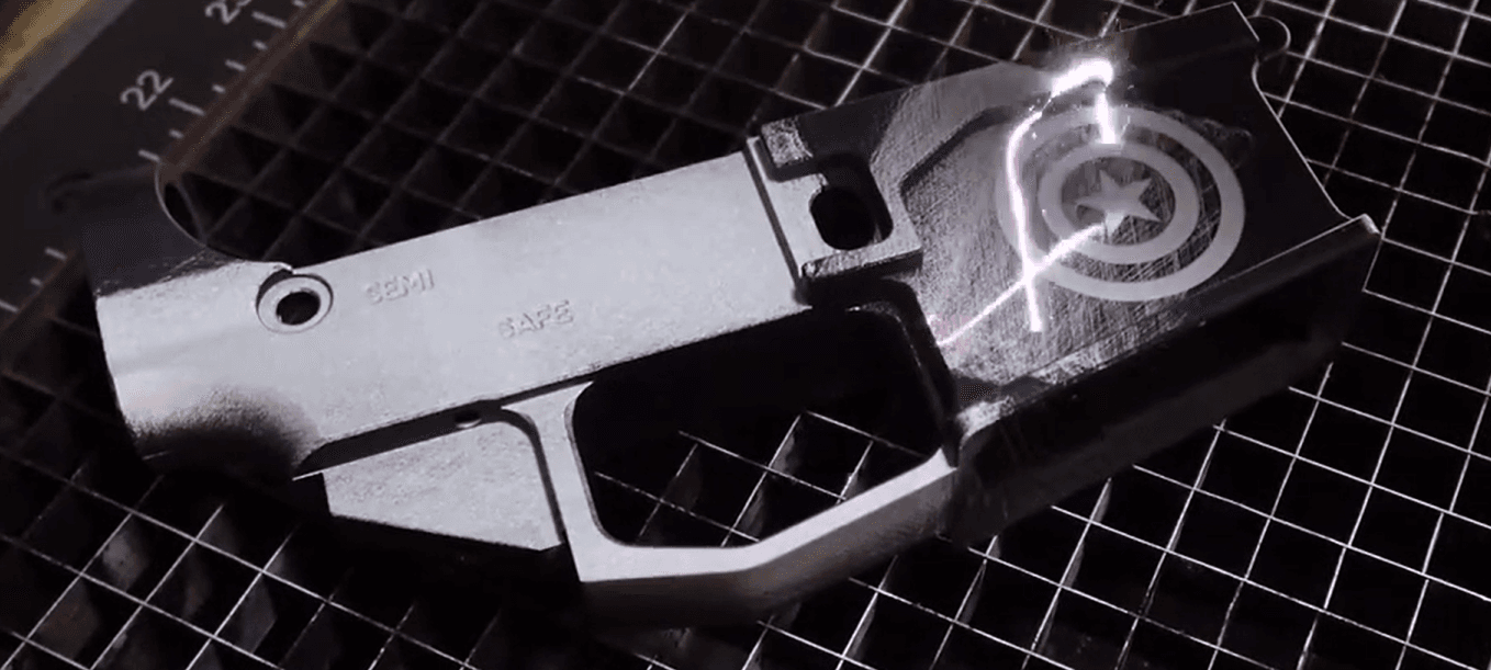 Firearm component during laser cleaning with carbon fouling and surface contamination removed